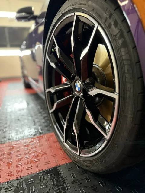 BMW wheel after detailing — clean, glossy, brake dust removed