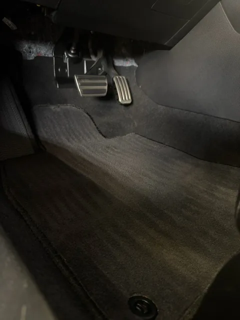 Car floor and pedals after detailing — clean, debris-free carpet