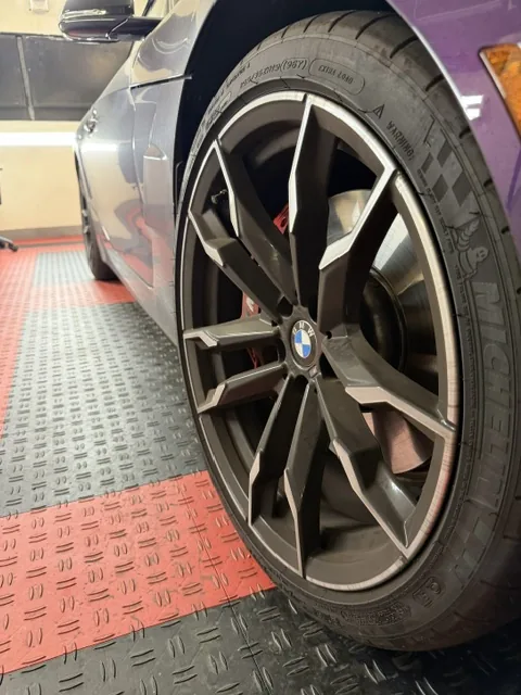 BMW wheel before detailing — covered in brake dust and grime