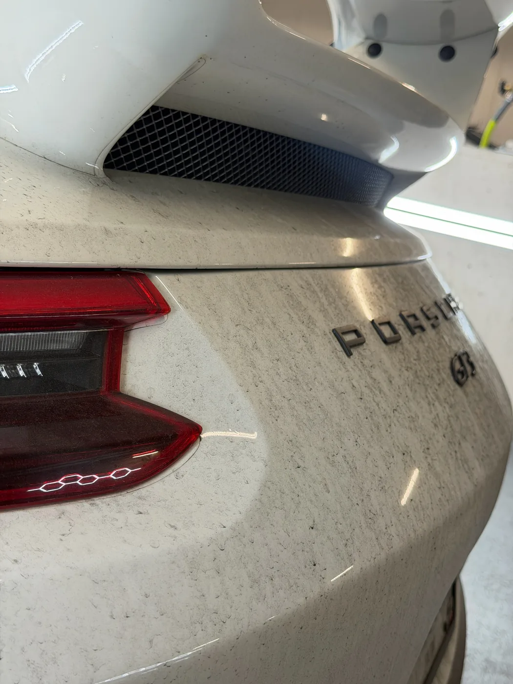 Porsche 911 GT3 rear before detailing — covered in dust and road grime