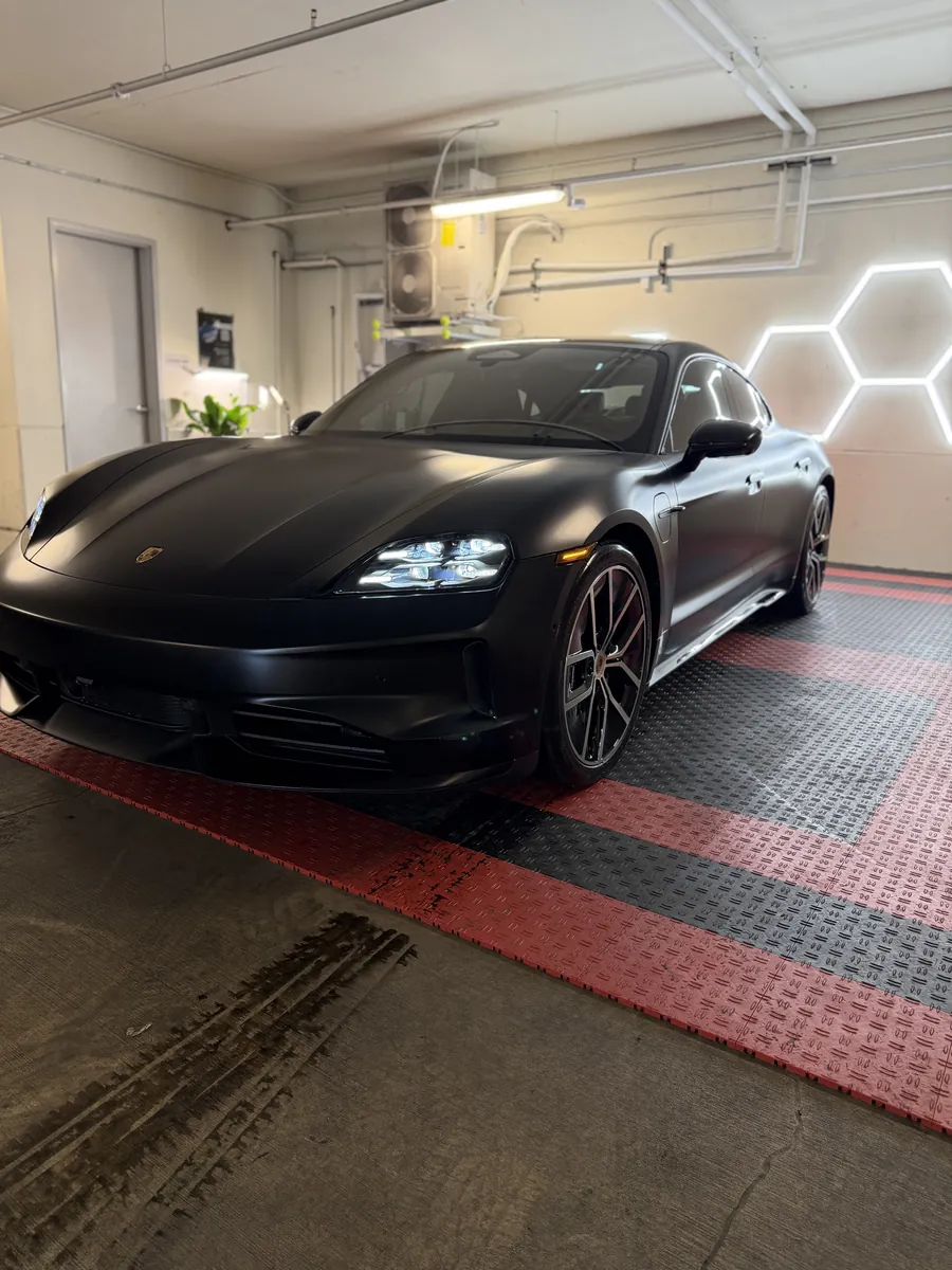 Freshly detailed matte black car in the Apollo Auto Detailing shop
