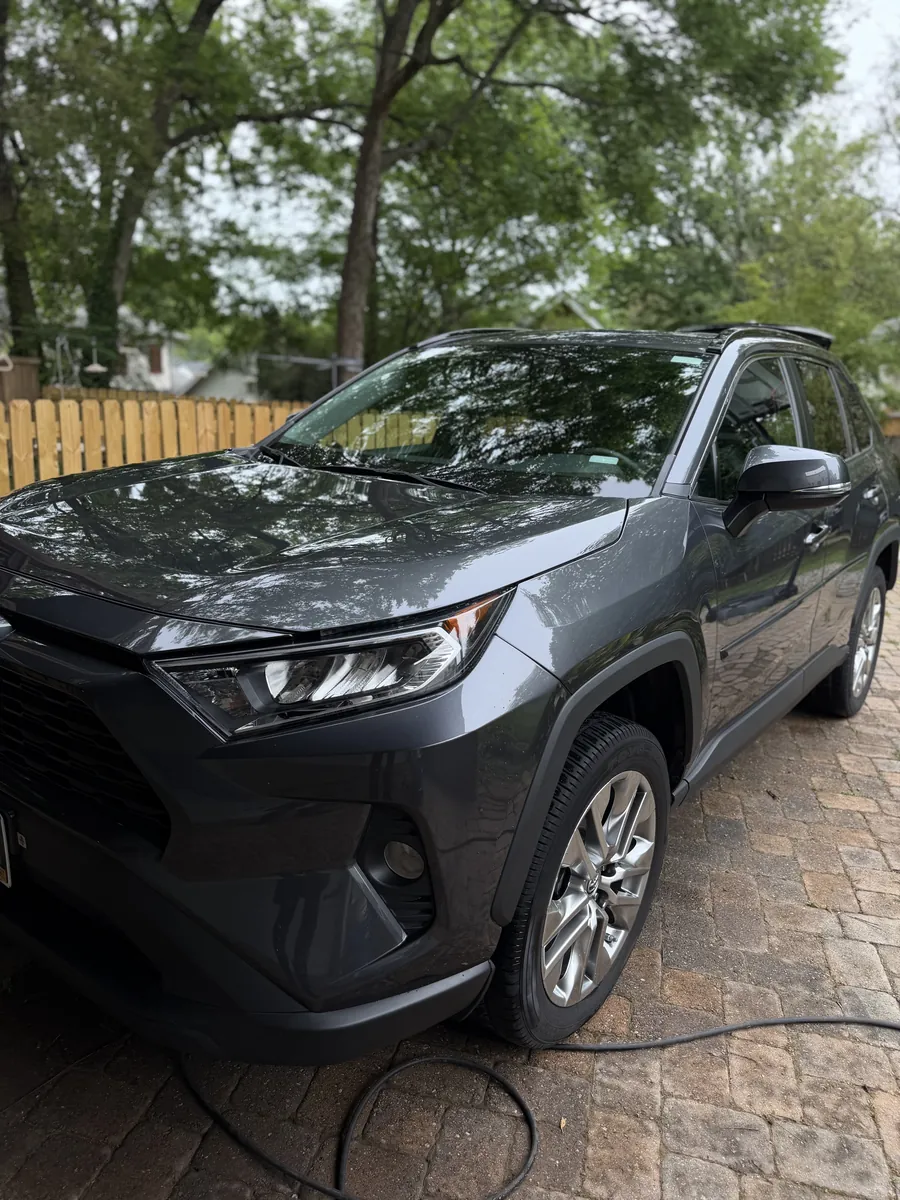 Mobile detailing service on an SUV in a driveway